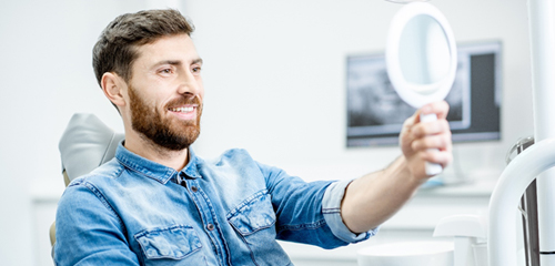 happy dental patient with mirror