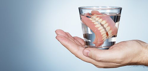 dentures in a cup of water 