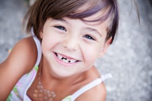 child with missing teeth