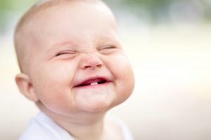 teething baby crawling on flloor