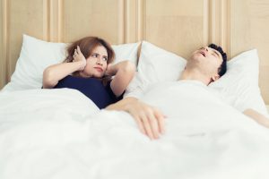 woman annoyed by partner’s snoring